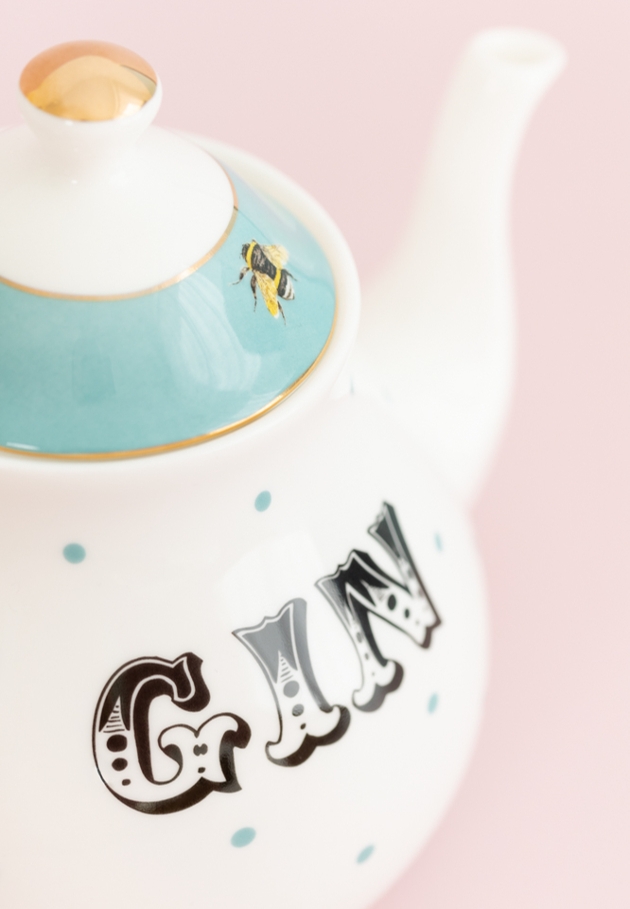 white tea pot with GIN written on it 