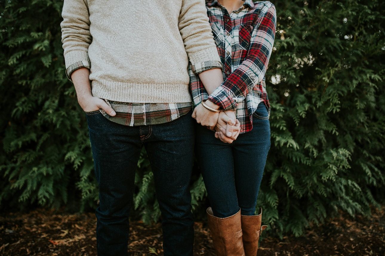 couple in casual clothes on a walk holding hands